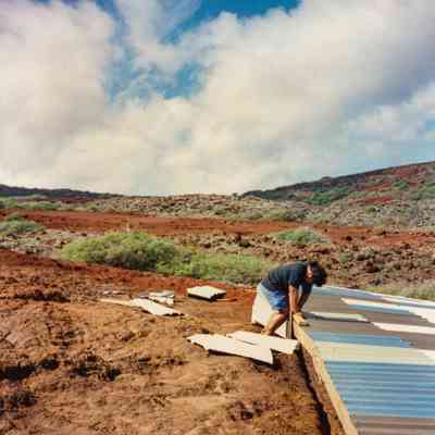 Person working on a water catchment structure