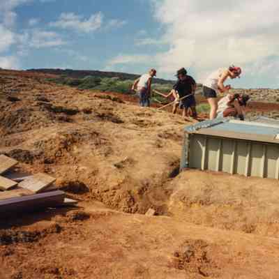 People working on and near metal water catchment structure