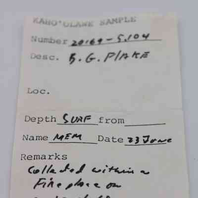 Artifact slip for basaltic glass flake: The artifact slip shows sample details with number, description, location, depth, name, date, and remarks, handwritten for documentation purposes.