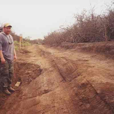 An unidentified man in trench along road