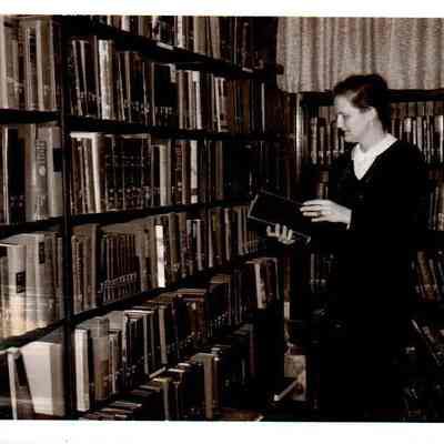 Mrs. John B. Shewmaker browses the stacks when the library was at Morgan Row