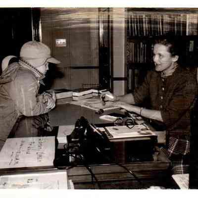 Mrs. John B. Shewmaker checks out books during Library Week in 1962.