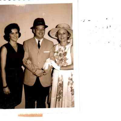 Modeling clothing from local stores are (L to R) Mrs. William B. Sharp, Joe Russell, and Mrs. Earl Cummins in 1963.