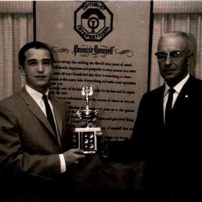 Hugh Young, President of the Pioneer Optimist Club, presents Chris Trower with a trophy for speech. (Dated 1963)