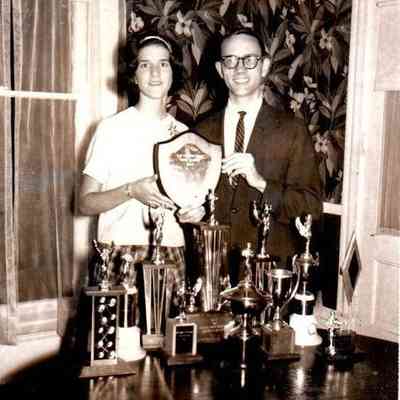 Dixie Moore and Davis Cornelius holding the debate of the year award and pictured with the many other awards they had obtained. Dated May 1963.