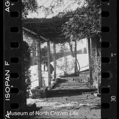 negative, sheet film - Snow Views : Child making snowman outside house (1937)