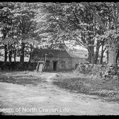 negative, glass plate - Unidentified stone buildings in a stand of trees.