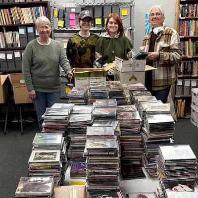 Wanderground volunteers sorting the Amazon Radion CD Donation - April 2025: L-R: Gail, Katie, Kat, M'lyn