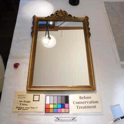 Wood-carved mirror frame with gold pigment