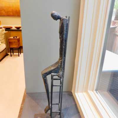 Tall man in chair