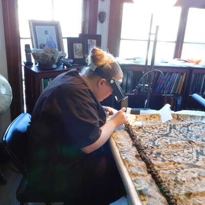 Kate sewing crepeline on drapery edge