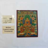 Seated figure with two small attendants