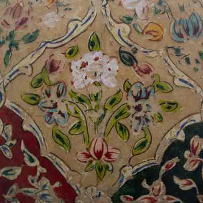 Camel bladder lamp: The camel bladder lamp features colorful floral patterns with vivid reds, blues, and greens intricately painted against a textured background.