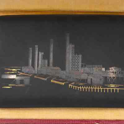 Cigarette case: The cigarette case displays a detailed oil refinery scene, enclosed in a blue case.
