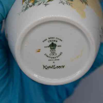 Bottom of ginger jar: The white base says, "Fine bone china, Crown est. 1901. Staffordshire, England, R. Kowloon."