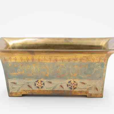 Rectangular cachepot: The image shows a brass rectangular cachepot decorated with intricate Arabic script and decorative patterns.