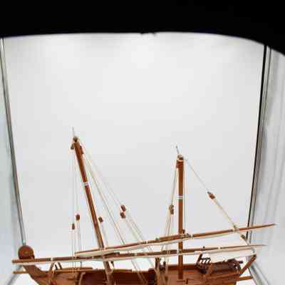 Miniature model dhow: A detailed miniature model of a Kuwaiti dhow sits on a wooden stand.