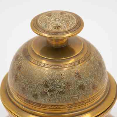 Meditation bell: The brass meditation bell features intricate leaf designs, beautifully engraved with floral patterns.