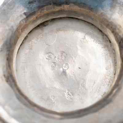 Bottom of one of the five-inch silver vases.: Up close image of the bottom of one of the silver vases. It is stamped with three maker's marks.
