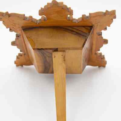 Back of the Mother of Pearl and olive wood Hindu temple shadow box.: Image of the back of the Mother of Pearl and olive wood shadow box. It is medium brown wood and has a leg that props up the box.