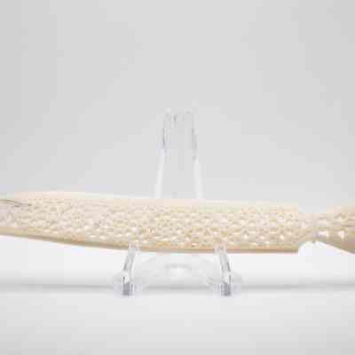 Small ivory letter opener from India.: Image of the small ivory letter opener with elephant on handle. It is decorated with cutouts in a floral pattern along the blade.