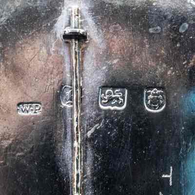 Stamps on bottom of ink stand: WP - William Plummer silversmith mark, first hallmark April 8, 1755, confirmed work for George III in 1777; Date Letter, obscured by pin - possibly B (1757), H (1763), I (1764), definitely between 1756-1775; Lion Passant Guardant mark - pre-1822 at least; London location mark