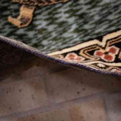 Side of rug: This image shows a close-up of a rug with intricate geometric patterns and earthy tones.