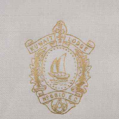 Kuwait Masonic Lodge seal on the inside of the lid.: Up close image of the printed gold seal of the Kuwait Masonic Lodge. The center of the seal has a Kuwaiti dhow and the bottom has the traditional Masonic compass. The seal reads "KUWAIT LODGE No 6810 . E.C."