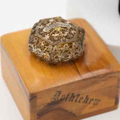 Metal and wood rosary boxes: An intricate metal box sits atop a wooden box marked "Bethlehem."