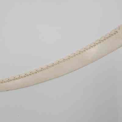 Carved ivory elephant letter opener.: Image of the large carved ivory letter opener with an elephant on the handle and 26 small elephants running down the length of the blade.