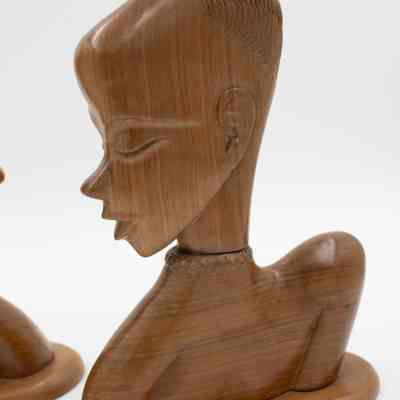 One of the carved wooden statuettes from Africa.: One of two matching carved wooden statuettes with twisted choker necklace. They are medium brown mahogany wood.