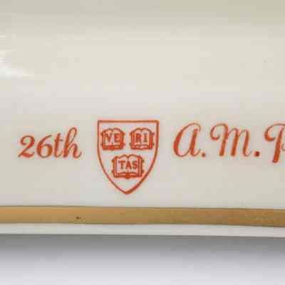 Closeup of "Veritas" logo: The crest is featured centrally with "26th" to the left and "A.M.P." to the right.