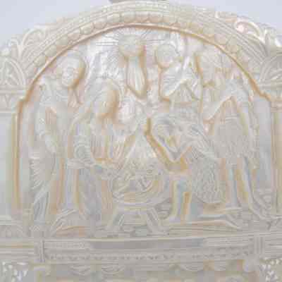 Jesus' Baptism: The image depicts an intricately carved Mother of Pearl bas relief plaque illustrating the Nativity, along with the Lord's Supper scene below.