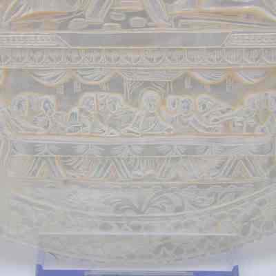 The Last Supper: The image depicts an intricate carved representation of the Last Supper.