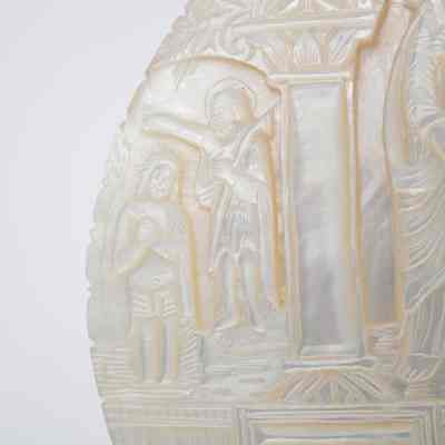 Bas relief: This image shows an intricately carved Mother of Pearl bas relief plaque, depicting various religious scenes with delicate detail.