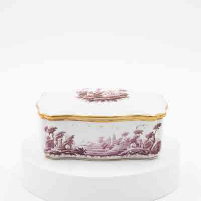 Cigarette box: A white ceramic cigarette box features burgundy pastoral scenes and is rimmed with gold.