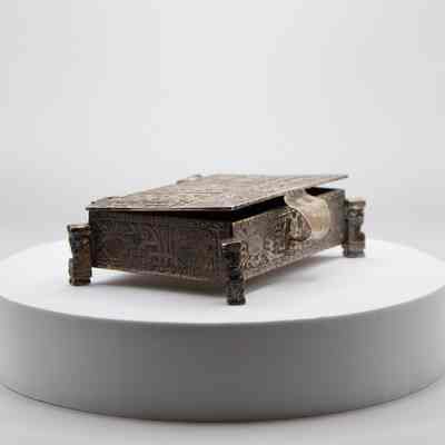 Cigarette box: The silver cigarette box features intricate Incan-style mythological art.