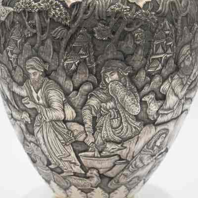Scene on the silver and brass urn from Persia.