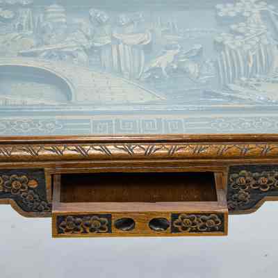 Drawer on coffee table: The carved wood Hong Kong coffee table features intricate designs and a partially opened drawer.