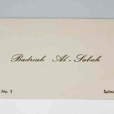 White notecard associated with the necklace and earring set.: Up close image of the white notecard found associated with the necklace. The card has black cursive in the center that reads "Badriah Al-Sabah" and "Tel No 1" in the bottom left corner and "Salmiah" in the bottom right.