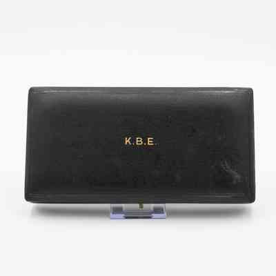 Outside of box: A black leather box with "K.B.E." in gold text.