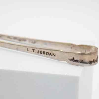 Side of tongs: The side of the tongs has "L.T. Jordan," engraved into it.