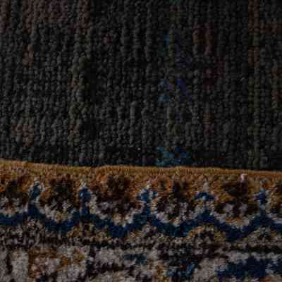 Large cream and blue area rug with deer: A detailed section of a rug features intricate patterns in cream and blue.