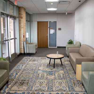 Large cream and blue area rug with deer: A large cream and blue area rug with deer patterns.
