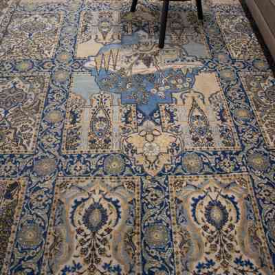 Large cream and blue area rug with deer: The large cream and blue area rug features intricate deer and floral designs.