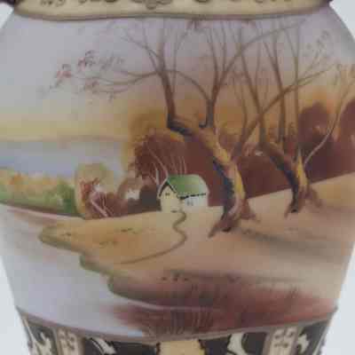 Painted scene on the small Nippon Japanese porcelain vase given to the Jordans by the Prime Minister of France.: Up close image of the painted pastoral scene with trees and fields extending to a horizon under a soft sky.
