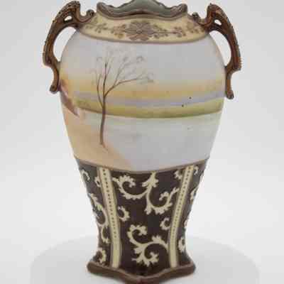 Back of the small Nippon Japanese porcelain vase given to the Jordans by the Prime Minister of France.: Image of the back of the porcelain vase painted with a pastel lake scene. The lower part displays a contrasting dark section adorned with swirling golden pattern.