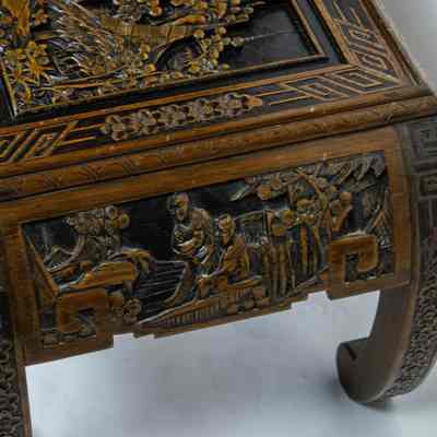 Side of coffee table: The coffee table features intricate carvings and elegantly arched legs, showcasing traditional craftsmanship.