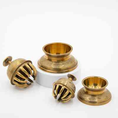 Set of brass meditation bells: A set of brass meditation bells featuring intricate leaf designs.