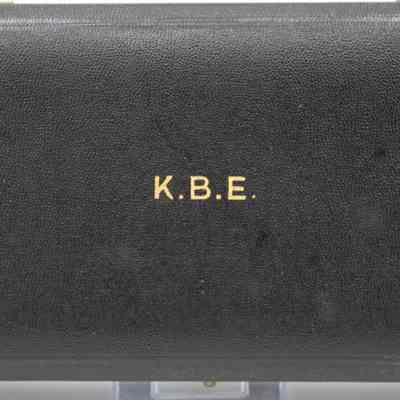 Outside of box: A black leather box with "K.B.E." in gold text.